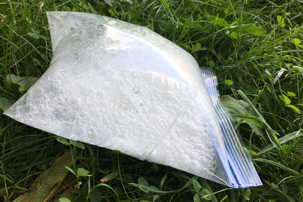 plastic ziploc bag filled with baking soda and vinegar and gas bubbles