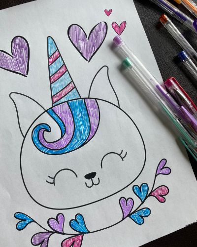 unicorn cat page colored in blue and purple with gel pens