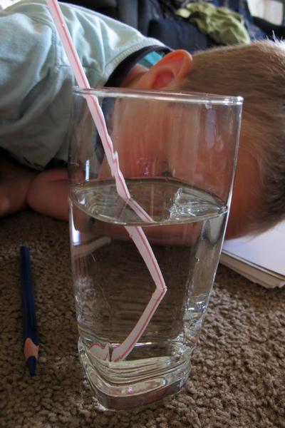 straw in a cup of water showing refraction of light