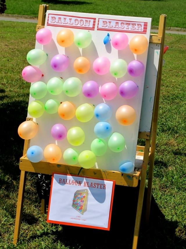 balloons taped to a board to throw darts at for a carnival party