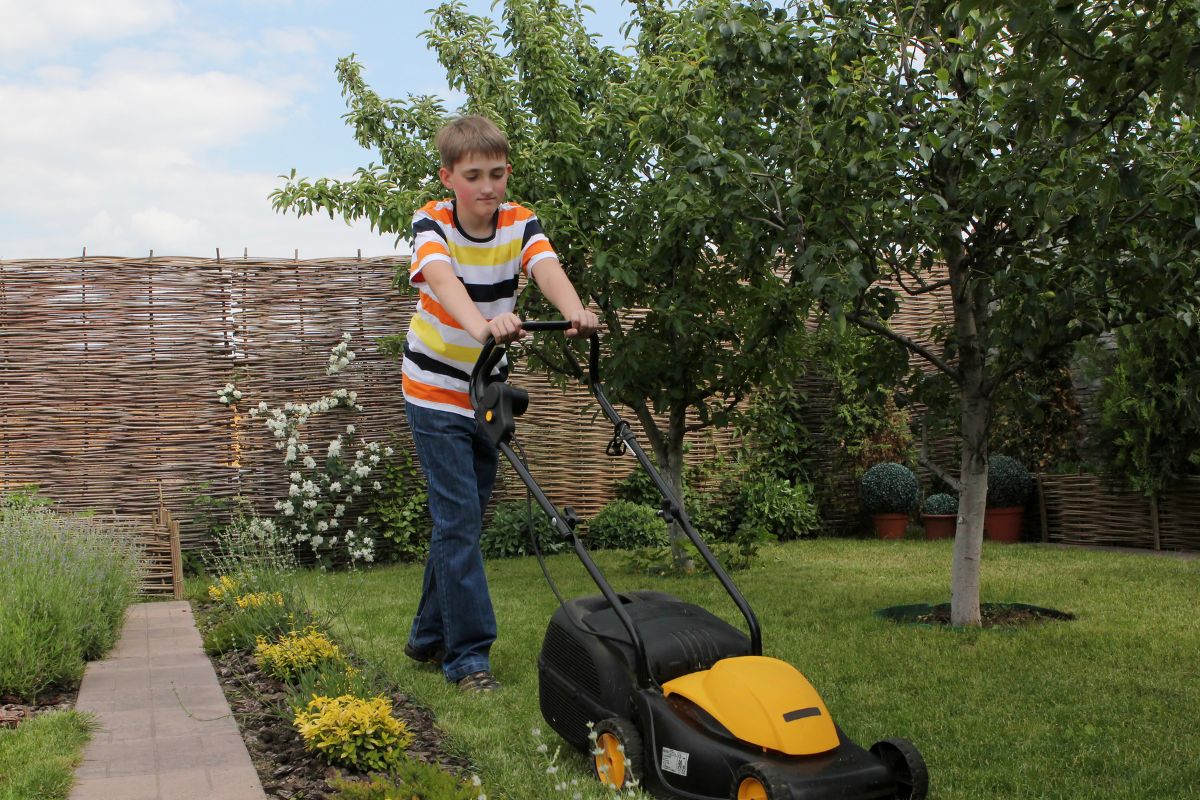 teen mowing lawn