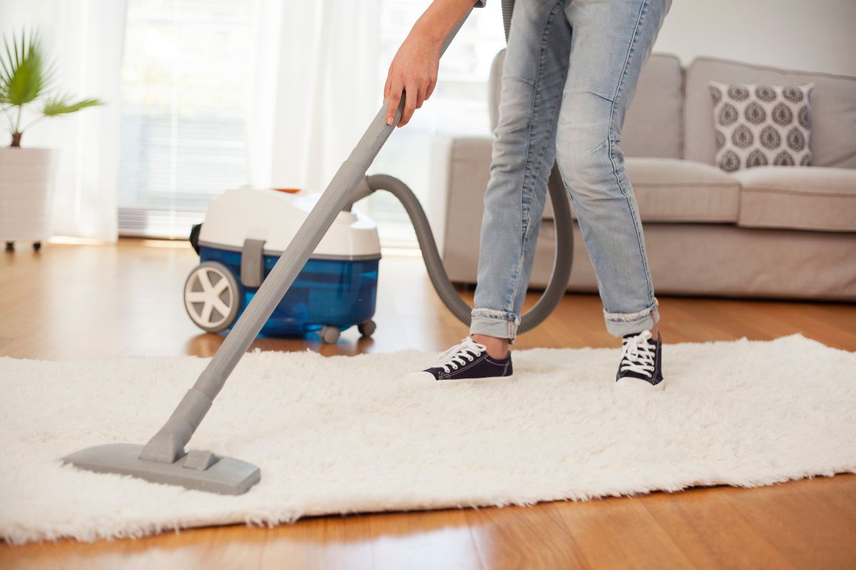 woman vacuuming rug
