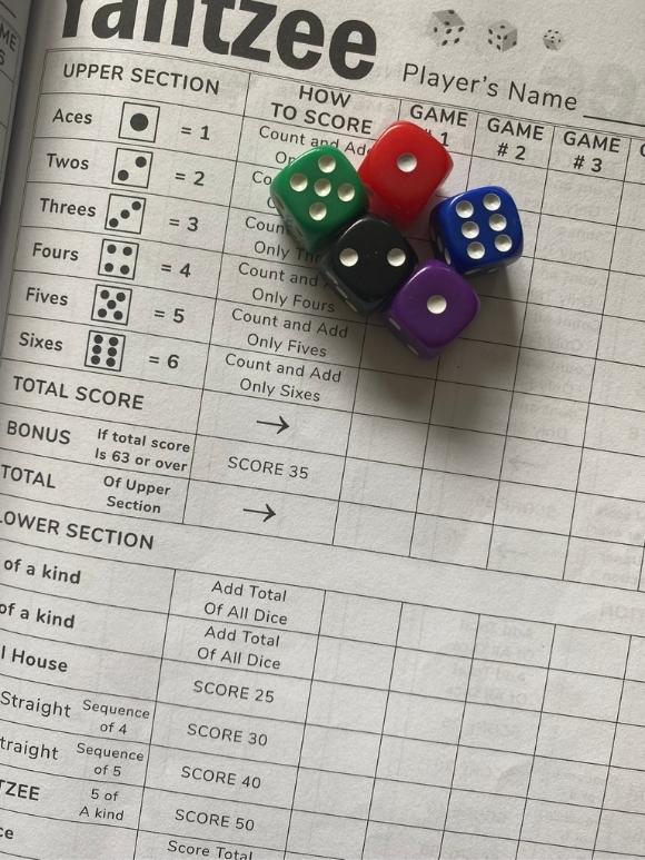 yahtzee game scoring paper with 5 colored dice